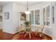 Bright breakfast nook with shutters and a glass table with comfortable chairs at 18241 Autumn Lake Blvd, Hudson, FL 34667