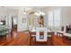 Open-concept dining room features a glass top dining table, seating for six, and bright sunlight at 18241 Autumn Lake Blvd, Hudson, FL 34667