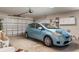 Garage featuring an attached blue vehicle and a functional garage door at 18241 Autumn Lake Blvd, Hudson, FL 34667