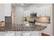 Kitchen with an island that features a sink and granite countertops at 18241 Autumn Lake Blvd, Hudson, FL 34667