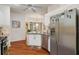 Well-lit kitchen featuring stainless steel appliances, white cabinets, and light-colored granite counters at 18241 Autumn Lake Blvd, Hudson, FL 34667