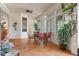 Covered patio featuring tile flooring, ceiling fan, and large windows providing ample natural light at 18241 Autumn Lake Blvd, Hudson, FL 34667