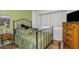 Comfortable bedroom featuring a metal frame bed, wooden floors, and natural light from the window at 1900 68Th N St # 110, St Petersburg, FL 33710