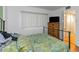 Cozy bedroom with wooden floors, natural light, and a chest for storage at 1900 68Th N St # 110, St Petersburg, FL 33710