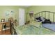 Bedroom featuring a metal frame bed, wooden desk, and decoratively painted walls at 1900 68Th N St # 110, St Petersburg, FL 33710