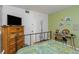 Bedroom with a chest, wooden floors, and decoratively painted walls at 1900 68Th N St # 110, St Petersburg, FL 33710