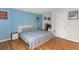 Well-lit bedroom featuring wood flooring, a bed with blue covers, and tasteful wall decor at 1900 68Th N St # 110, St Petersburg, FL 33710