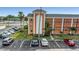 A three-story building with a tower and multiple balconies is surrounded by palm trees and a parking lot at 1900 68Th N St # 110, St Petersburg, FL 33710