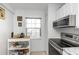 Bright kitchen featuring stainless steel appliances, white cabinets, and a granite countertop at 1900 68Th N St # 110, St Petersburg, FL 33710