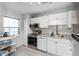 Bright kitchen features stainless steel appliances, white cabinets, granite countertops, and great natural light at 1900 68Th N St # 110, St Petersburg, FL 33710