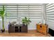 Living room featuring light-filtering shades, wood-look floors, and plants at 1900 68Th N St # 110, St Petersburg, FL 33710