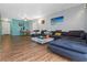 Bright living room boasts hardwood floors and a comfortable sectional sofa, perfect for relaxing and entertaining guests at 1900 68Th N St # 110, St Petersburg, FL 33710