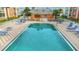 Clear blue pool is surrounded by blue lounge chairs and is adjacent to an orange community building at 1900 68Th N St # 110, St Petersburg, FL 33710
