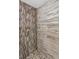 Close-up view of a stand-up shower with uniquely tiled walls and a rainfall showerhead at 1900 68Th N St # 110, St Petersburg, FL 33710