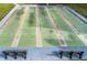 Several outdoor shuffleboard courts are positioned between two benches at 1900 68Th N St # 110, St Petersburg, FL 33710
