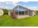 Expansive backyard with a screened-in lanai provides a perfect blend of indoor/outdoor living and greenery at 2159 Warwick Dr, Oldsmar, FL 34677