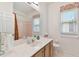 Bright bathroom featuring a vanity, large mirror, and tiled shower with tub at 2159 Warwick Dr, Oldsmar, FL 34677