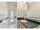 Bright bathroom with outside access featuring a modern vanity and tiled accents at 2159 Warwick Dr, Oldsmar, FL 34677