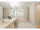 Bright bathroom with double sinks, a large mirror, and a separate tub and shower at 2159 Warwick Dr, Oldsmar, FL 34677