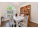 Bright dining room featuring elegant white furniture and hardwood floors at 2159 Warwick Dr, Oldsmar, FL 34677
