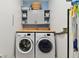 Functional laundry room with front load washer and dryer, cabinet storage, and a folding counter at 2159 Warwick Dr, Oldsmar, FL 34677
