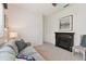 Inviting living room with carpet floors, a cozy sofa, and a dark wood fireplace at 2159 Warwick Dr, Oldsmar, FL 34677