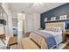 Comfortable main bedroom featuring a blue accent wall, wood floors, and stylish decor at 2159 Warwick Dr, Oldsmar, FL 34677