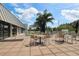Inviting outdoor patio area with tables and chairs, perfect for dining and relaxing with scenic views at 2159 Warwick Dr, Oldsmar, FL 34677