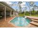 Spacious screened-in pool area with a waterfall feature and well-maintained brick patio at 2159 Warwick Dr, Oldsmar, FL 34677