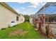Side yard with a green lawn and tropical plants, offering a private and serene outdoor space at 2159 Warwick Dr, Oldsmar, FL 34677