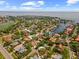 An aerial view of the neighborhood highlighting the subject property with a red pin near golf course and water access at 219 Rialto Ne Way, St Petersburg, FL 33704
