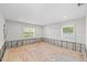 Renovated bedroom with new floorboards, exposed concrete walls, and mini-split air conditioning unit at 219 Rialto Ne Way, St Petersburg, FL 33704