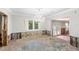 Dining room features an elegant chandelier and large window, currently undergoing renovations with exposed walls and subfloors at 219 Rialto Ne Way, St Petersburg, FL 33704