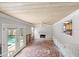 Bright living room with fireplace, view of pool, and undergoing renovations with exposed framework at 219 Rialto Ne Way, St Petersburg, FL 33704