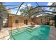 Covered patio area featuring a pool with a built-in hot tub and ample space for outdoor seating at 219 Rialto Ne Way, St Petersburg, FL 33704
