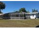 Enclosed screened-in porch, perfect for outdoor living, with a view of the backyard at 22237 Lockport Ave, Port Charlotte, FL 33952