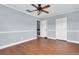 Bedroom with hardwood floors and ceiling fan featuring a closet, and access to the upstairs landing at 2647 Barksdale Ct, Clearwater, FL 33761
