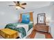 Cozy bedroom with a plush bed, window, and classic wood dresser for ample storage at 2647 Barksdale Ct, Clearwater, FL 33761