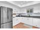 Bright kitchen with white cabinets, modern appliances, and a window that provides natural light at 2647 Barksdale Ct, Clearwater, FL 33761