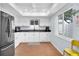 Bright kitchen with white cabinets, modern appliances, and a window that provides natural light at 2647 Barksdale Ct, Clearwater, FL 33761