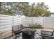 Back patio featuring a modern outdoor seating arrangement, privacy fencing, and mature shade trees at 2647 Barksdale Ct, Clearwater, FL 33761