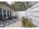 Back patio featuring a modern outdoor seating arrangement, privacy fencing, and garden bed at 2647 Barksdale Ct, Clearwater, FL 33761