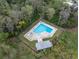 Aerial view of a community pool area surrounded by lush greenery, lounge chairs, and a shaded cabana at 2647 Barksdale Ct, Clearwater, FL 33761