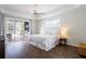 Calming bedroom with hardwood floors and views of the screened-in pool area at 3027 Key Harbor Dr, Safety Harbor, FL 34695