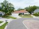 Charming single-story home featuring a well-manicured lawn, a three-car garage, and a circular driveway at 3027 Key Harbor Dr, Safety Harbor, FL 34695