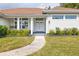 Inviting front entrance with double doors, manicured landscaping, and a well-lit walkway at 3027 Key Harbor Dr, Safety Harbor, FL 34695
