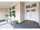 Cozy front porch with rocking chairs and decorative plants, perfect for relaxing and enjoying the outdoors at 3027 Key Harbor Dr, Safety Harbor, FL 34695