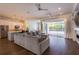 Inviting living room flowing into the kitchen, offering a view of the pool through large sliding glass doors at 3027 Key Harbor Dr, Safety Harbor, FL 34695