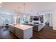 Bright living room features hardwood floors, an island kitchen, and a cozy fireplace at 3027 Key Harbor Dr, Safety Harbor, FL 34695
