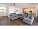 Spacious living room features a large sectional sofa, wood floors, and seamless open-concept design at 3027 Key Harbor Dr, Safety Harbor, FL 34695